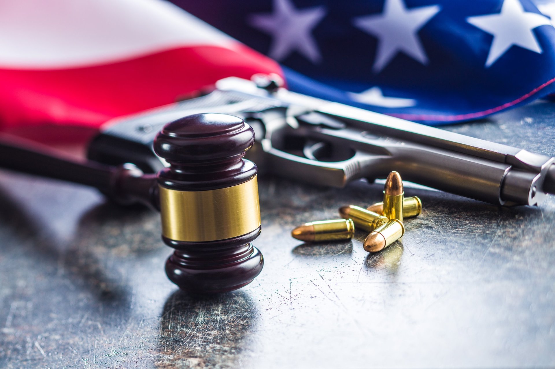 Legal compliance concept with gavel and gun